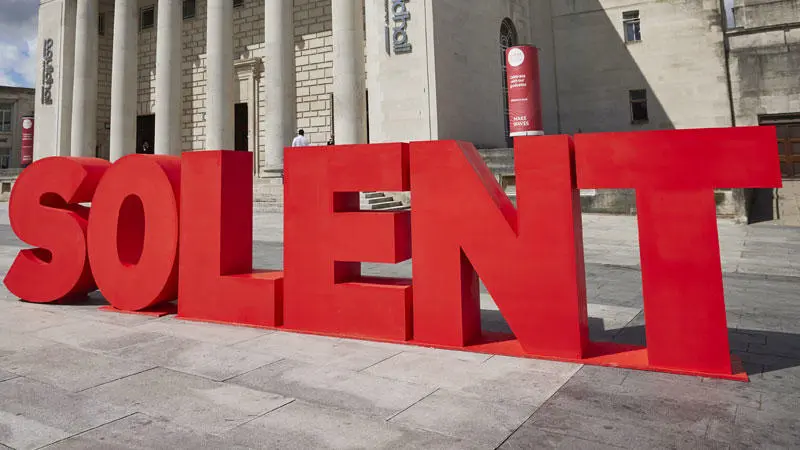 Solent spelt outside a building with big letters