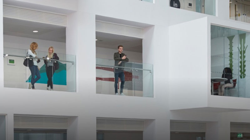 People standing in the breakout areas on each level of the Spark