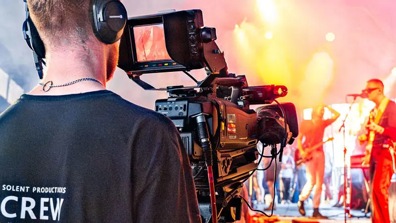A TV production student filming an act at Glastonbury Festival