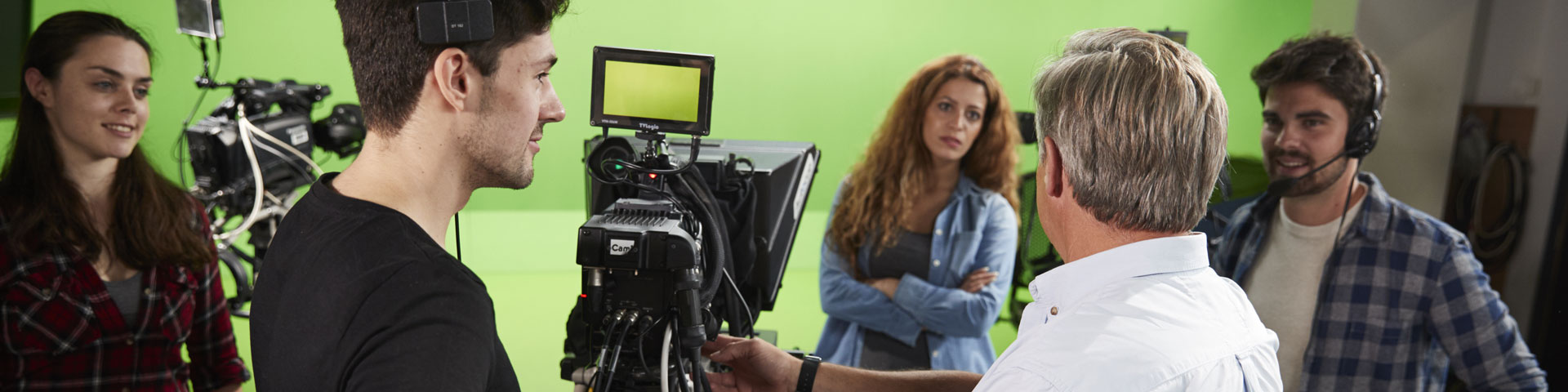 A group of students in a television studio with a camera