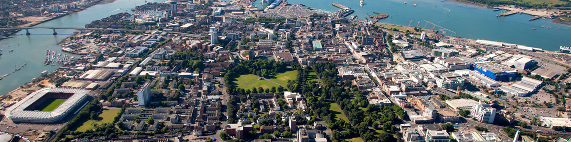 A colour picture of Southampton from above with the water at top, the countryside to the right and the football ground to the right.