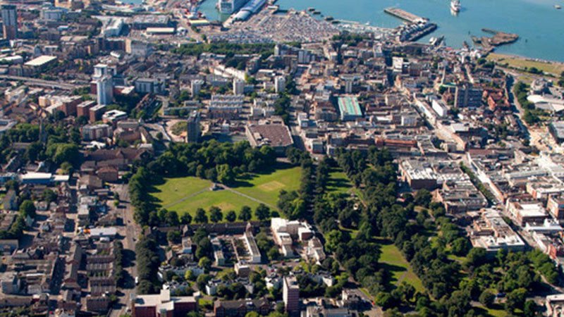 A colour picture of Southampton from above with the water at top, the countryside to the right and the football ground to the right.