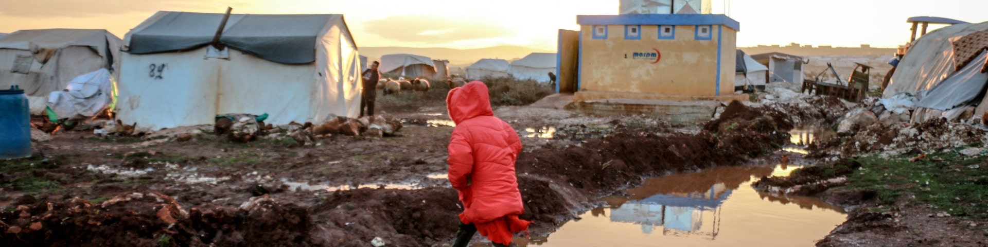 Child walking through a war-torn area