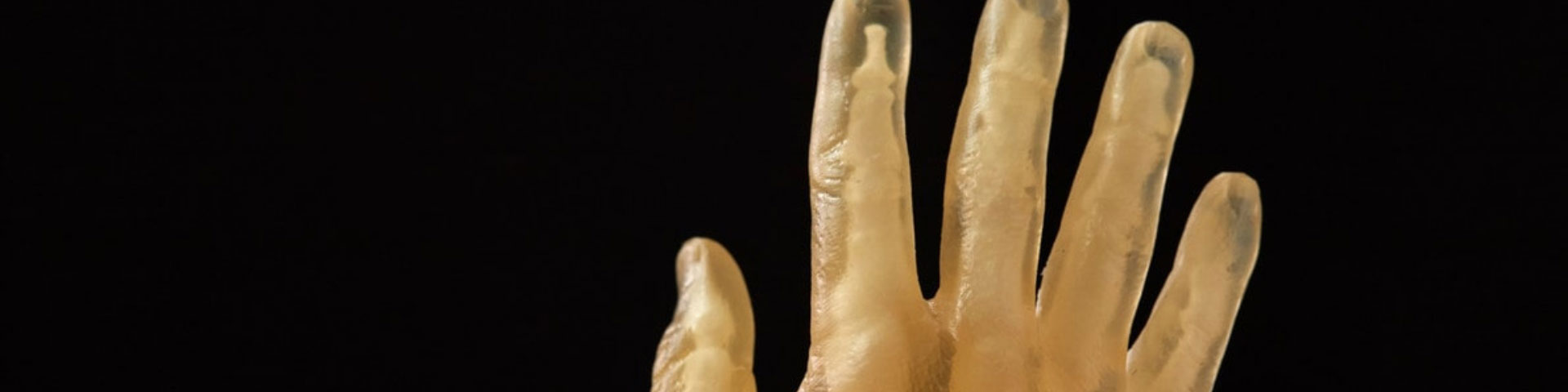 A computer rendered yellow hand on a black backdrop.