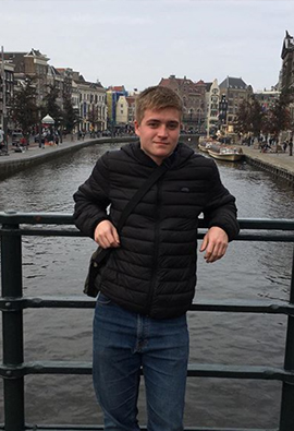 Sports journalism student, Chris Elliot standing on a bridge