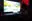 Avi at his desk with a large TV and laptop