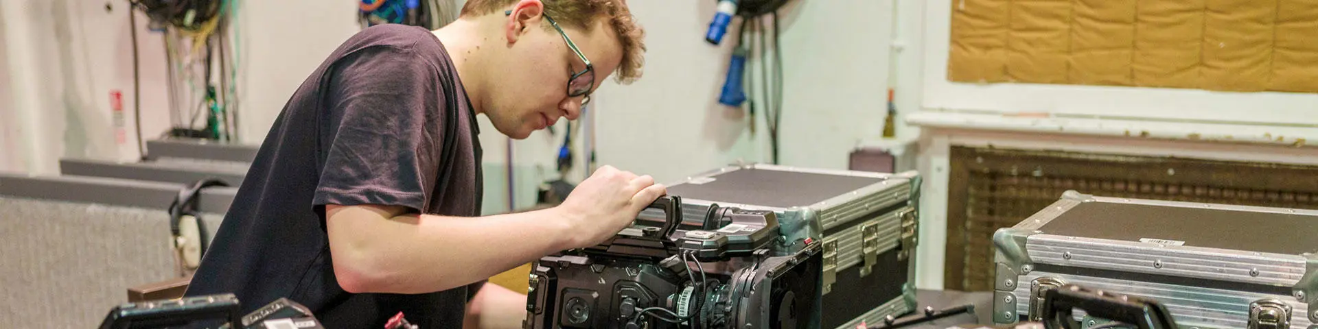 student setting up camera equipment 