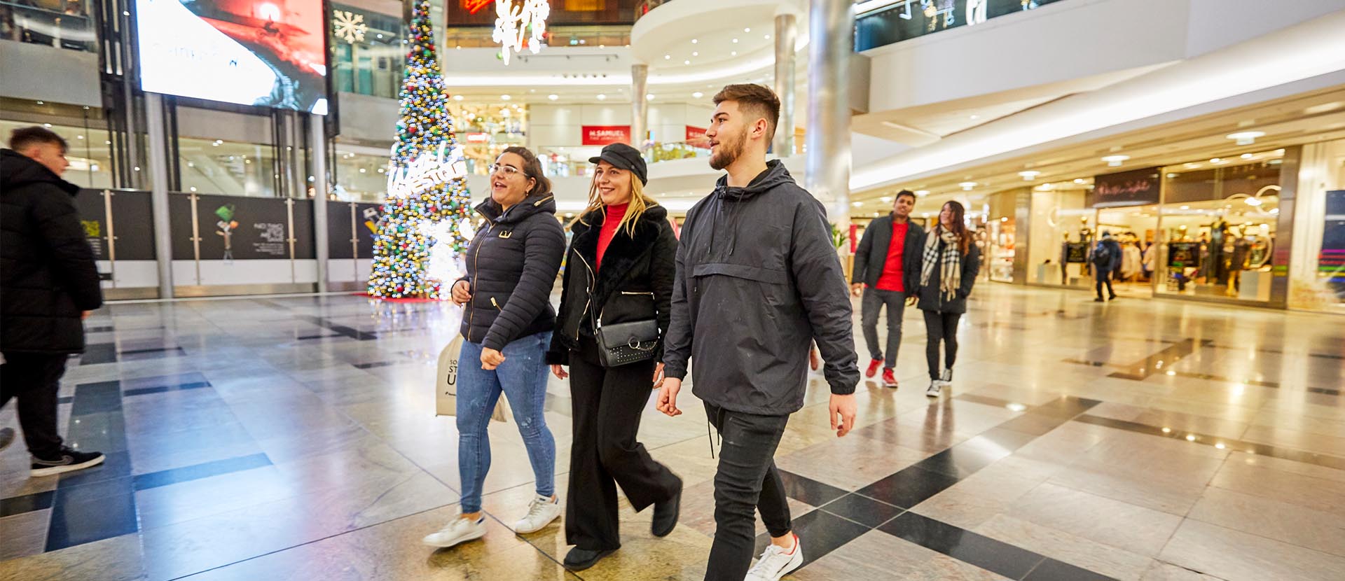 Three students walking through Westquay shopping centre