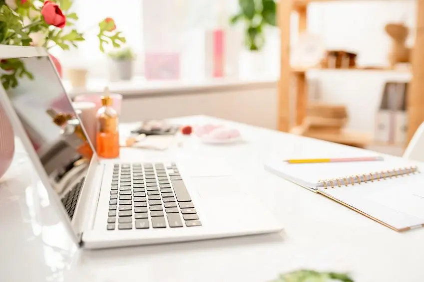 image of laptop and notebook on a desk