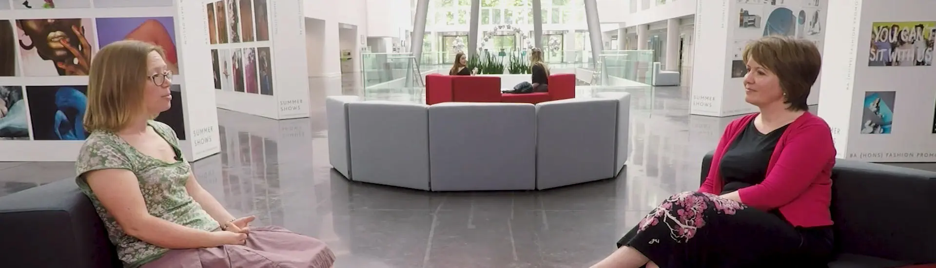 lecturers having a discussion in the atrium