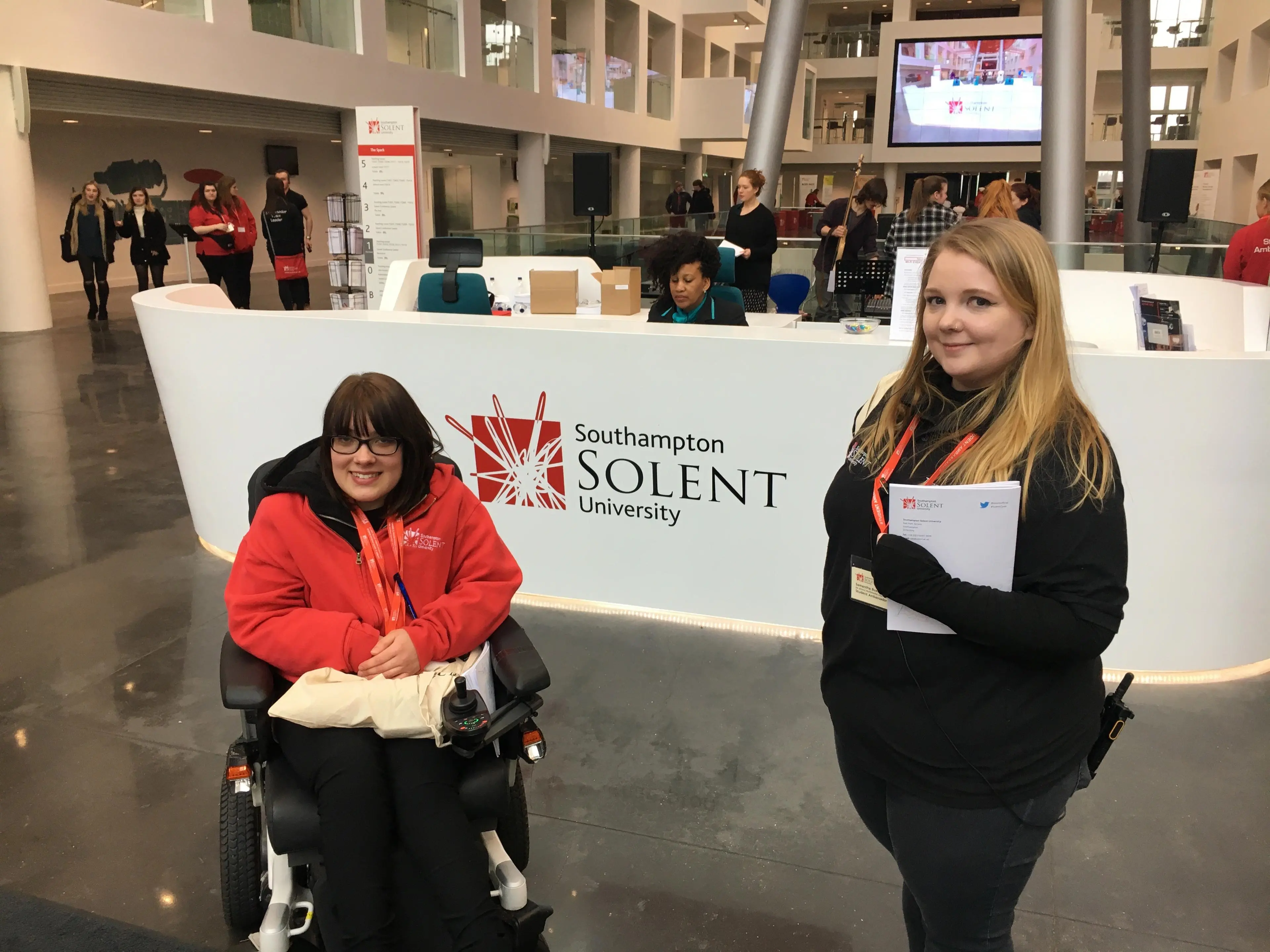 Students stood in front of The Spark reception desk
