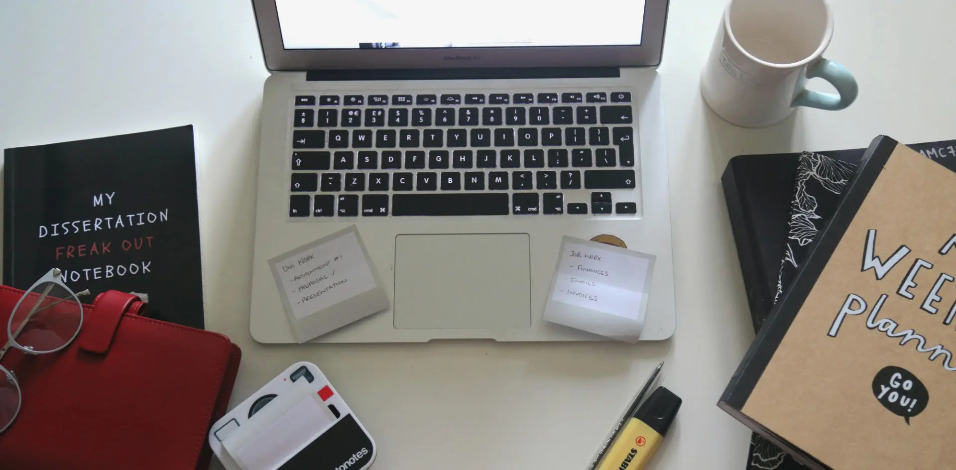 Books, post-its, a laptop, a highlighter, a cup and planner. Credit Emma Townley