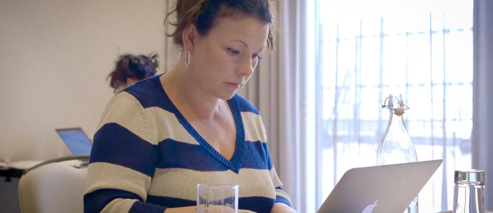 Lady typing on a laptop