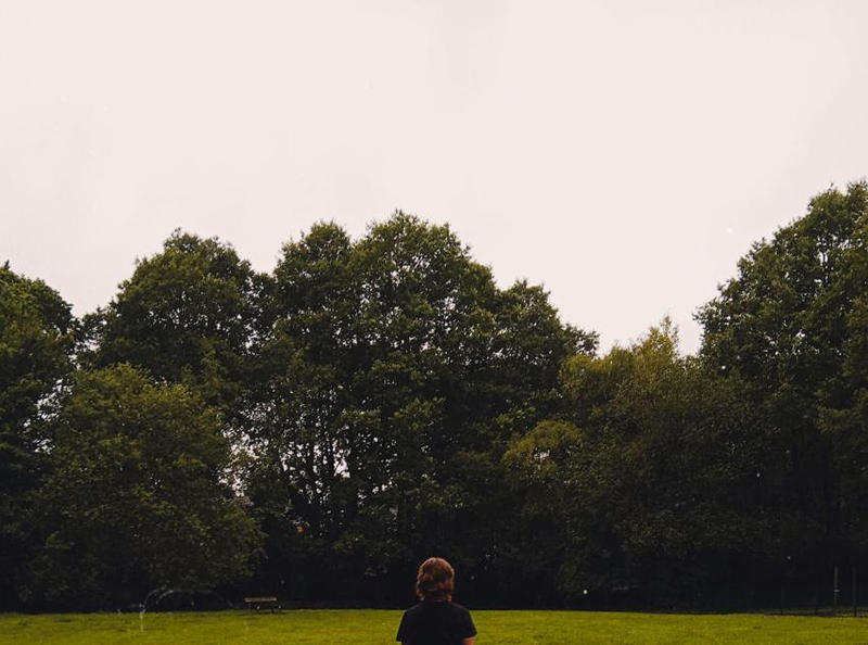 Abigail in a field walking away