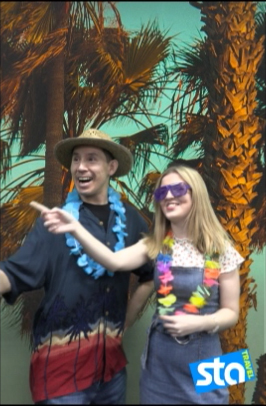 Male and female students wearing flower garlands