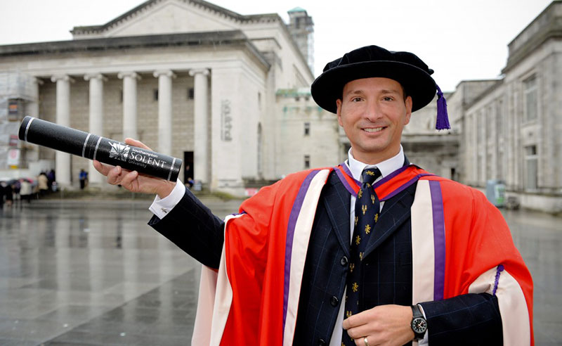 Barry Laden MBE FRSA with his honorary degree outside the Guildhall in Southampton