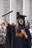 Shivani holding a scroll in the air outside Guildhall Square