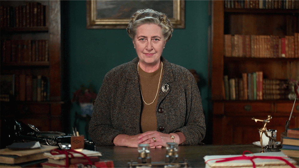 A woman sat at a desk in a library.