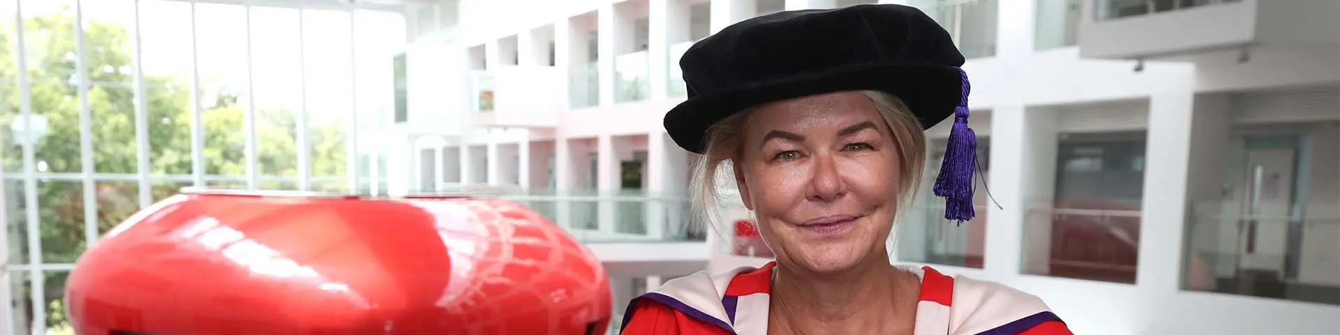Alex Crawford in her honorary doctorate gown in the Spark building