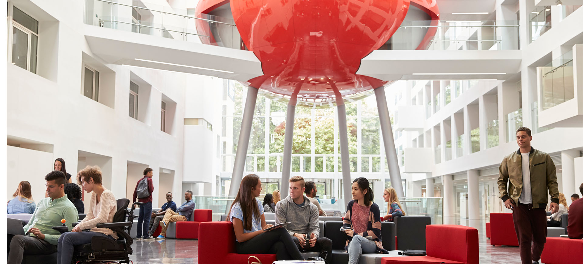 staff and students in the University's atrium of The Spark building