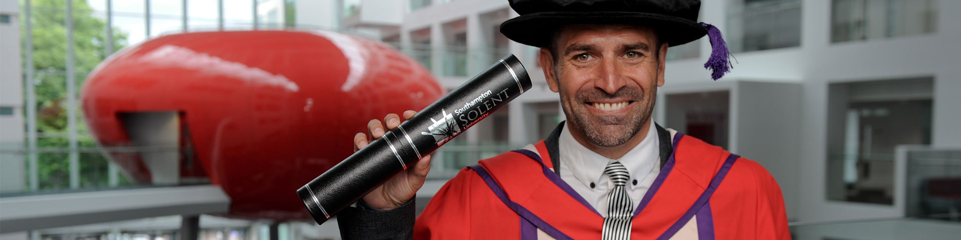Francis Benali with his Hon Doc certificate