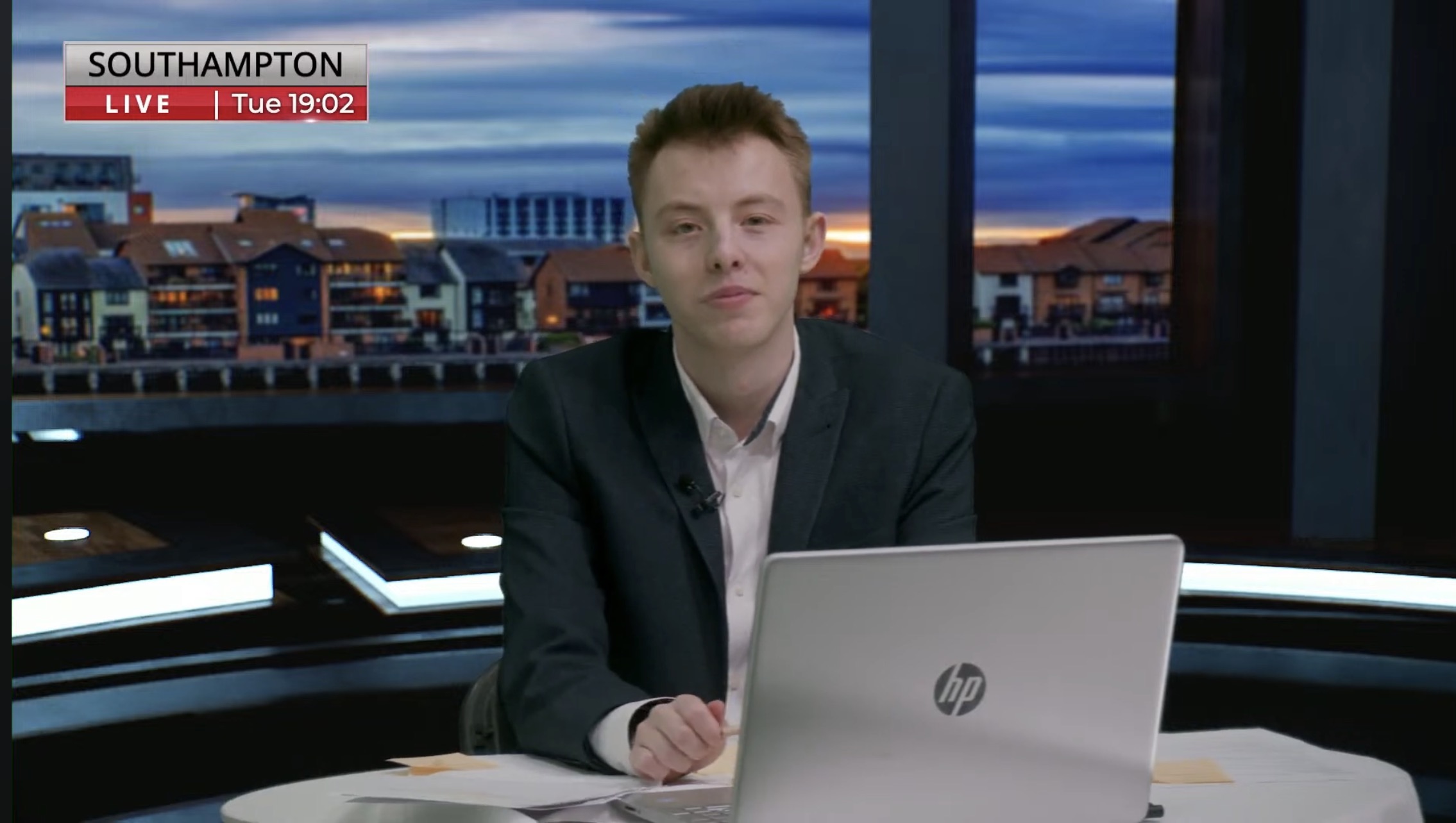 Cameron Jarvis with a newsroom background