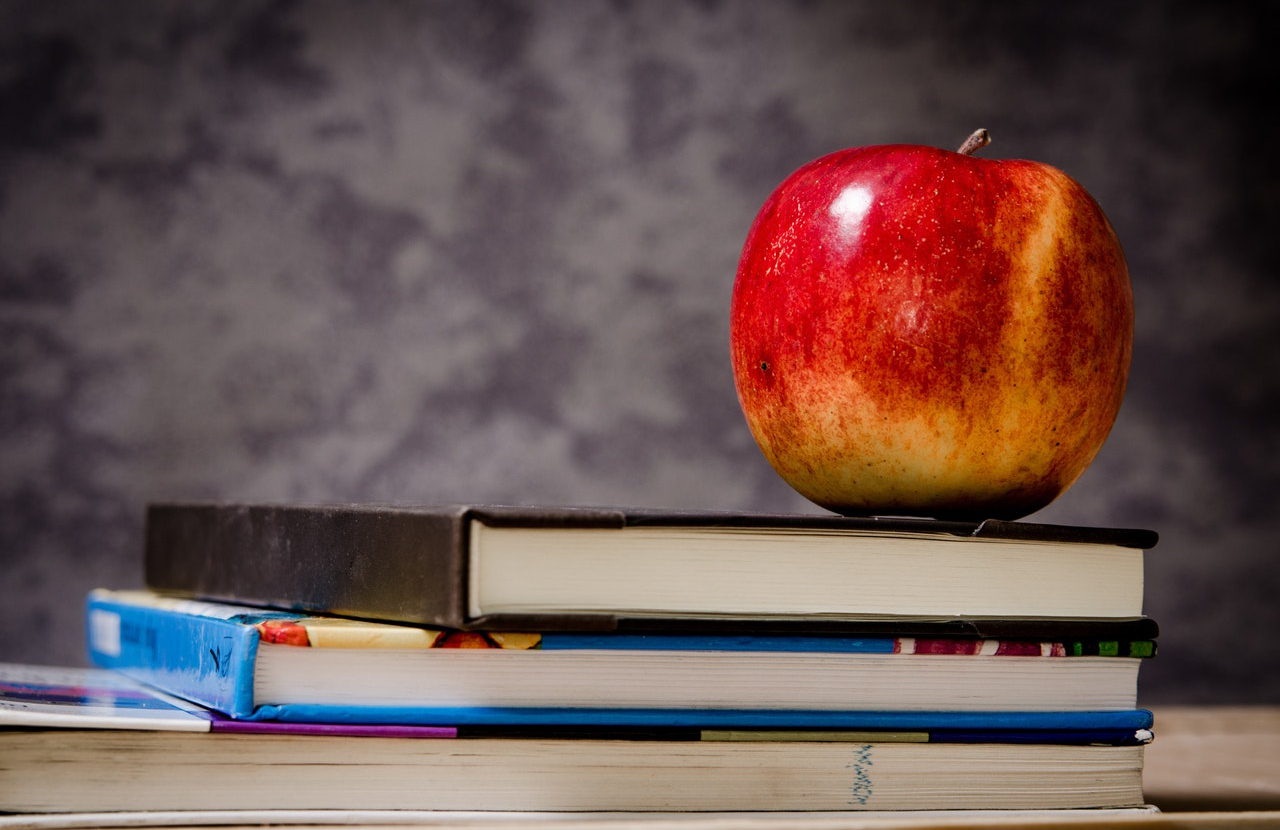 An apple on some books