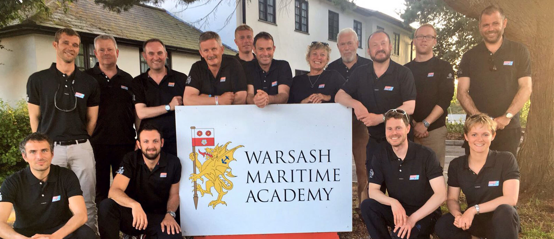 Skippers around the Warsash Maritime Acdemy sign