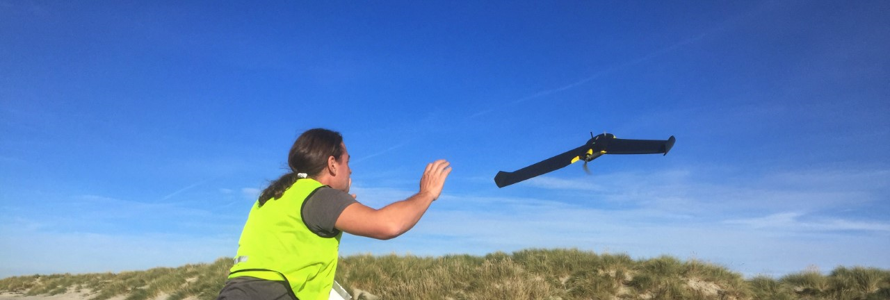 Man using Unmanned Aerial Vehicles to scan coastline