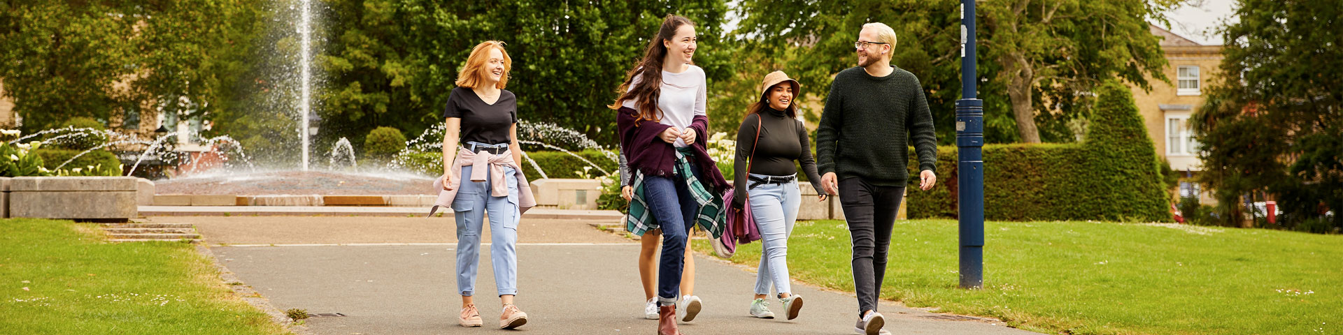 A group of students walking through the park
