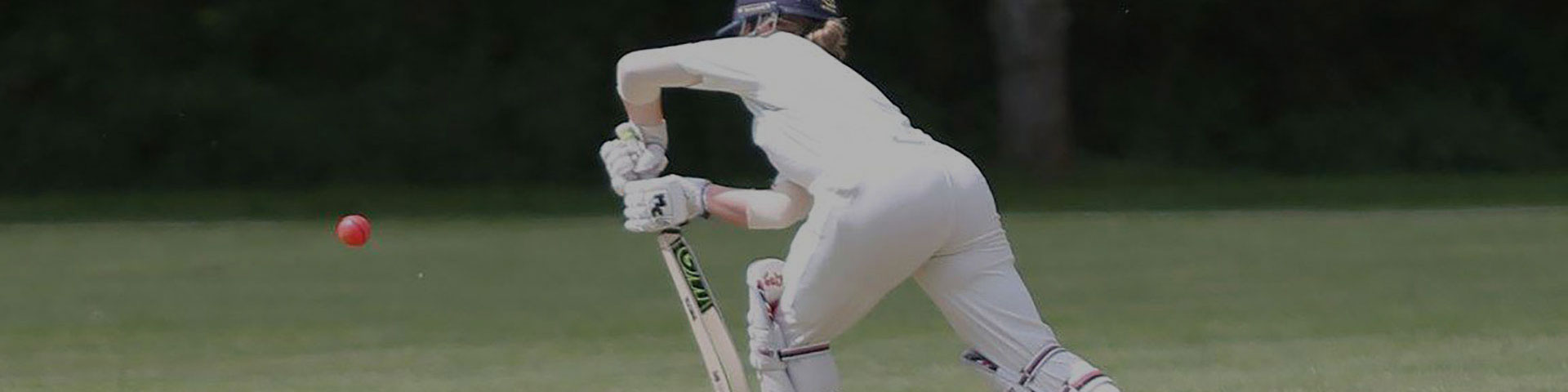 A cricketer batting the ball