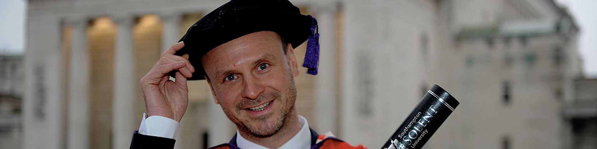 David McKendrick with his degree outside the Guildhall