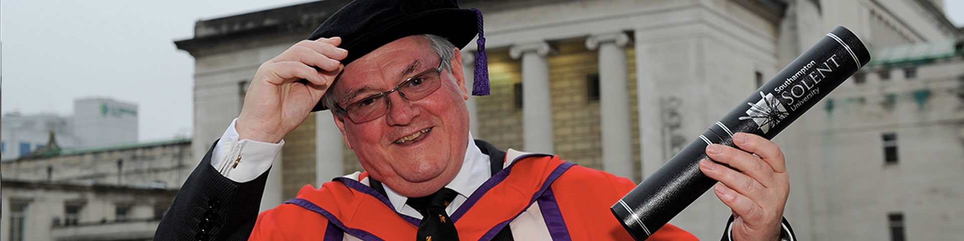 Doug Barrow with his honorary degree outside the Guildhall in Southampton