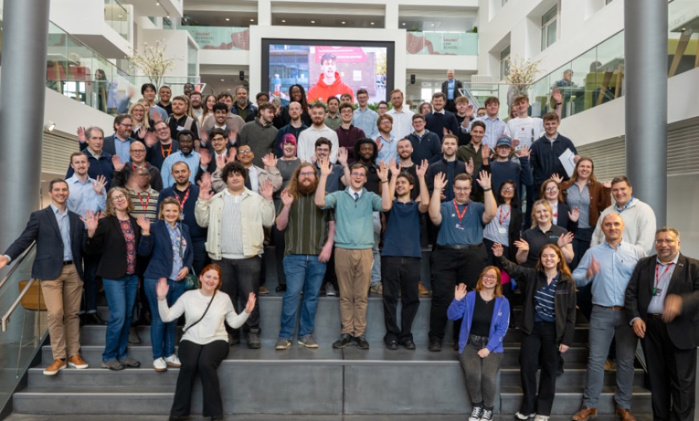 students and event attendees on steps in the spark