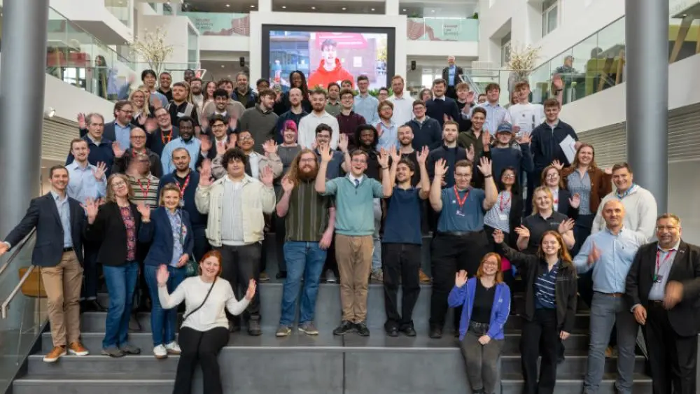 students and event attendees on steps in the spark