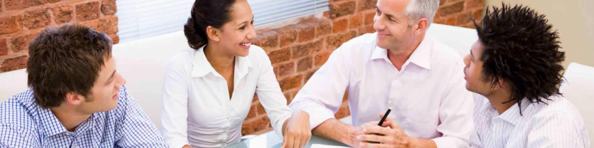 Four business people having a discussion around a table