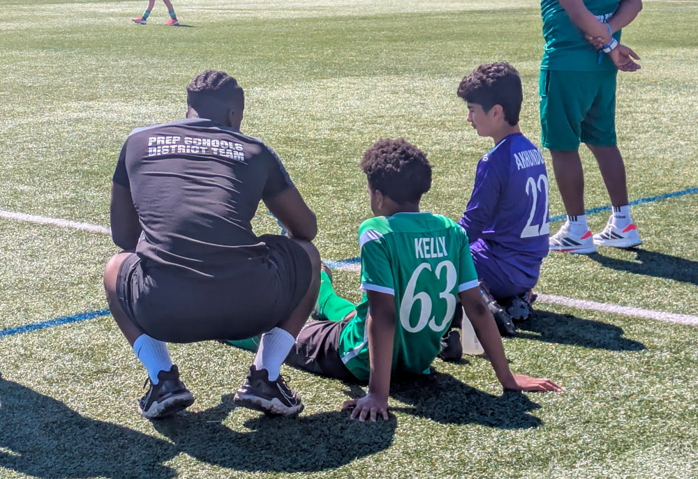 A member of Solent's Football Studies course helps the youth players