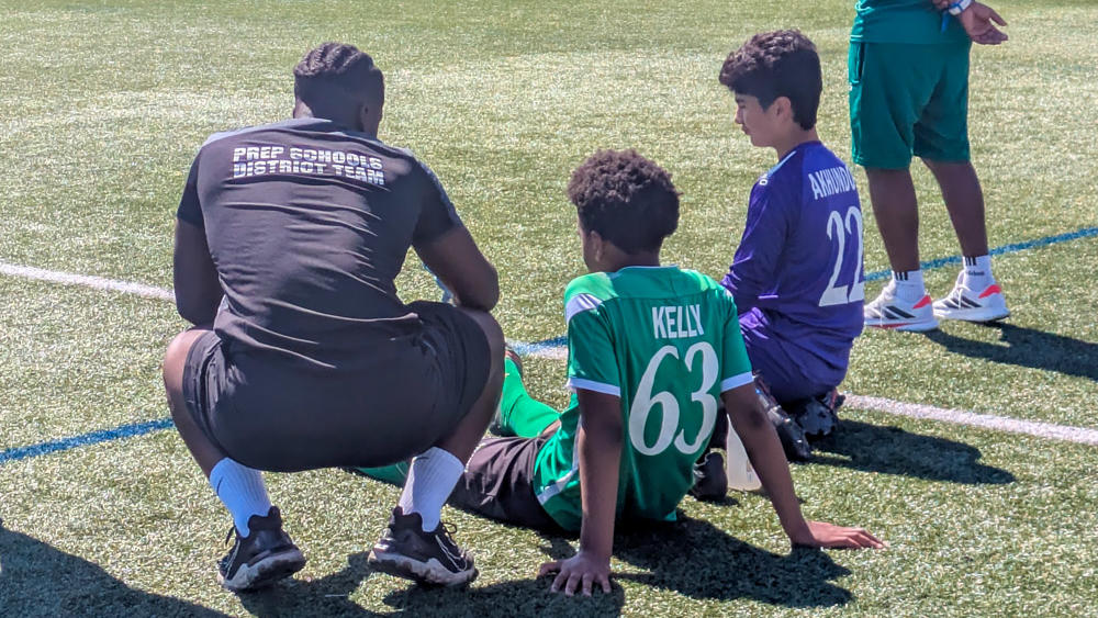 A member of Solent's Football Studies course helps the youth players
