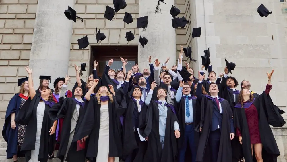 Students throwing caps in air at graduation