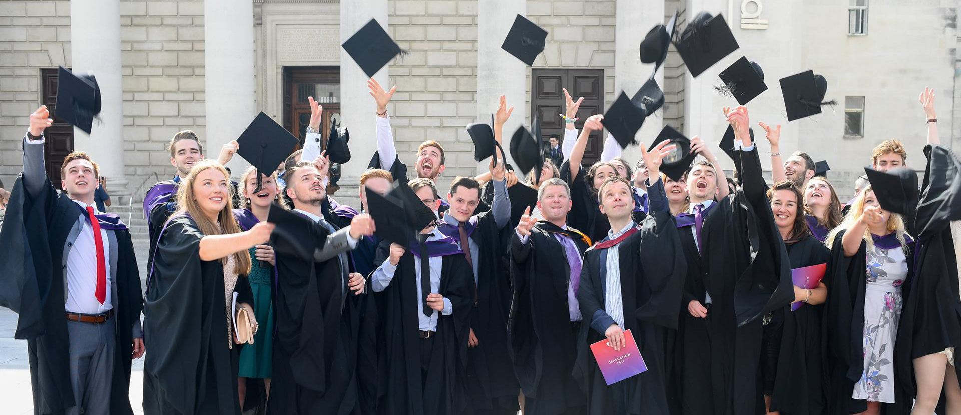 Solent graduates throwing hats in the air