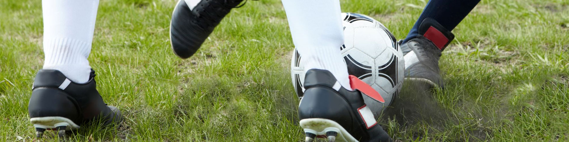 two football players' legs mid tackle