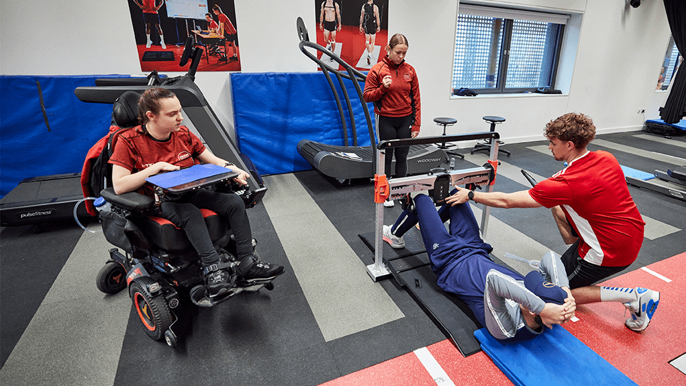 Three students carrying out testing on a cricket player at Solent University.