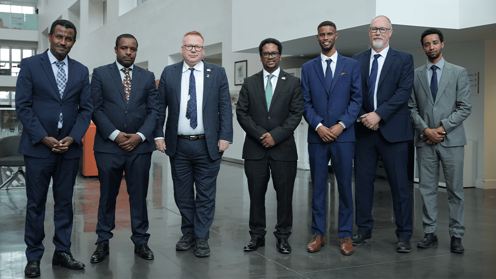 A group of seven men stood together in The Spark Atrium.