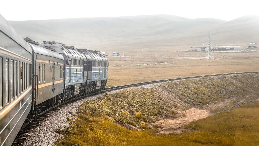 A train travels through the countryside