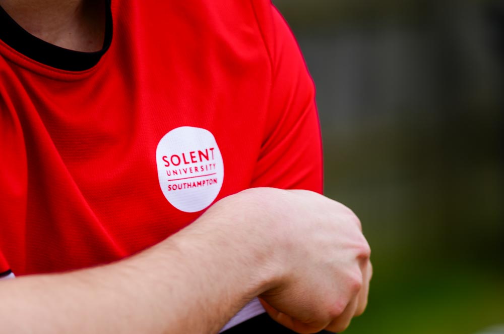 Solent Men's Football captain adjusts his captain's armband