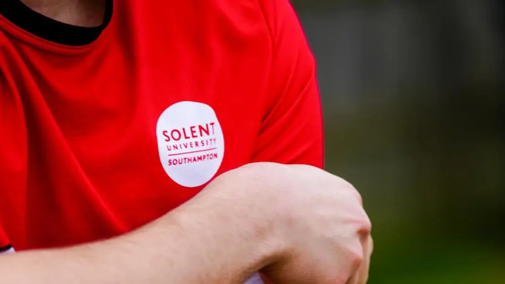 Solent Men's Football captain adjusts his captain's armband