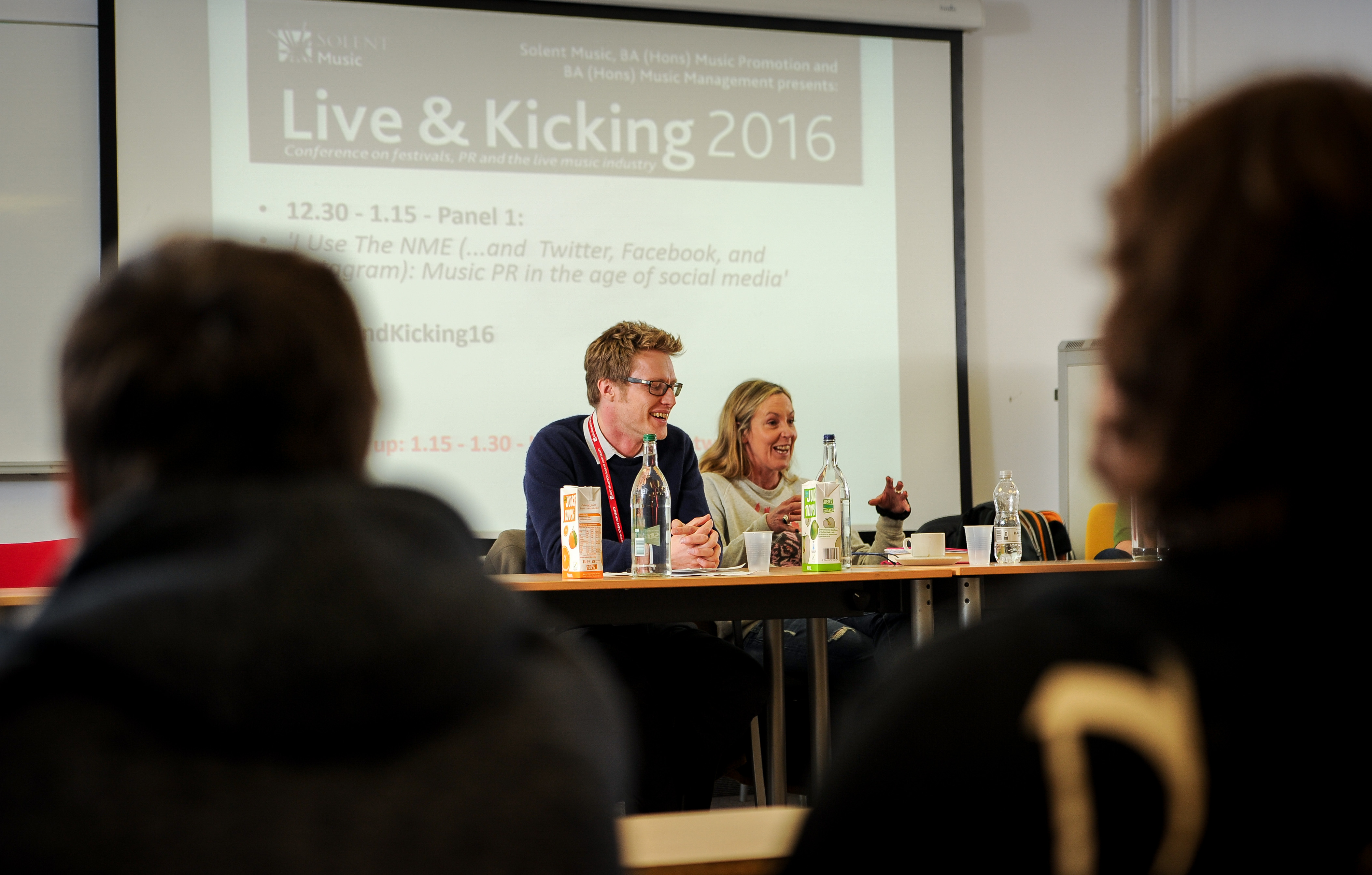 Industry figures talking at a conference