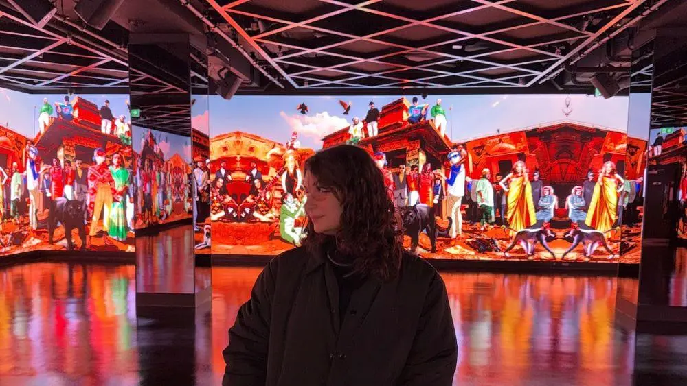 Melody Perry in front of a digital screen