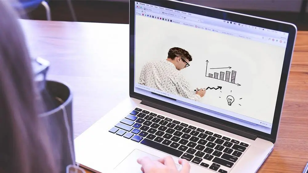 someone looking at a webinar on a laptop