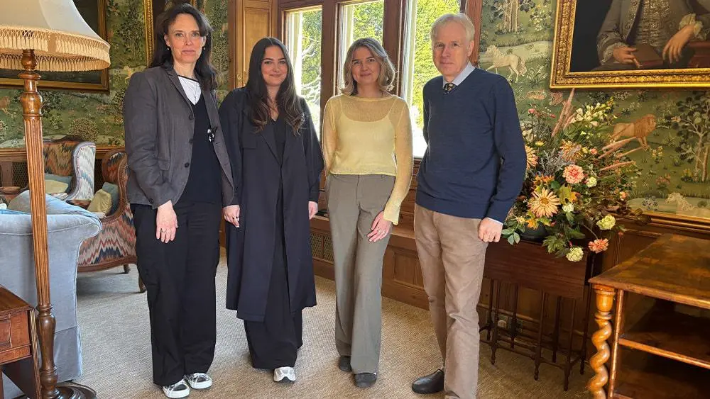 Lydia Southwell with two graduates and Lord Montagu.